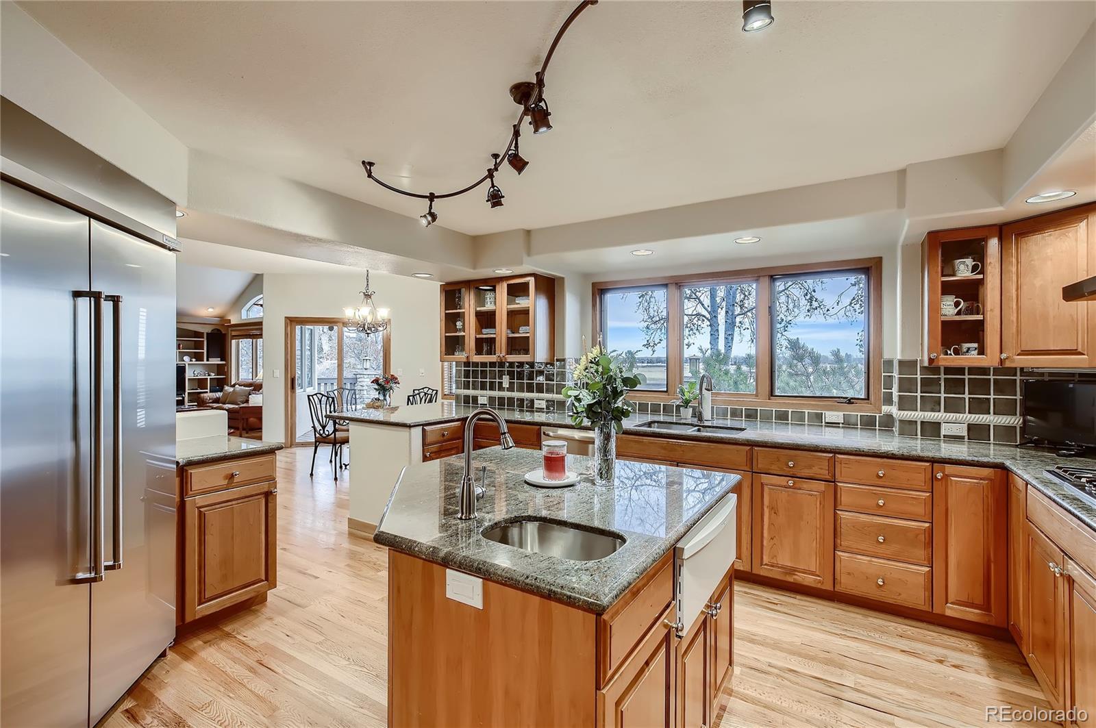 7748 Crestview Lane Niwot, CO 80504 - Photo 8 of 40 a kitchen with stainless steel appliances granite countertop a sink and wooden cabinets