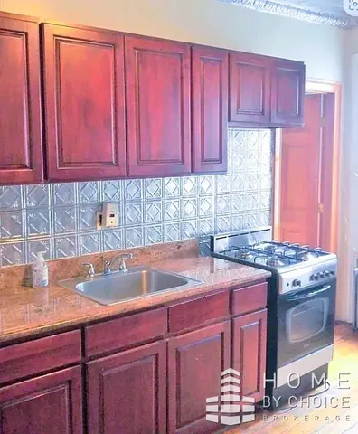 a kitchen with a sink cabinets and window