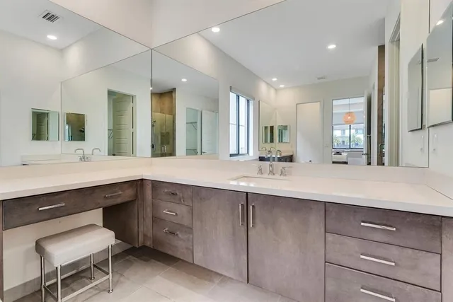 a bathroom with a double vanity sink and a mirror
