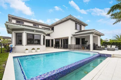 a view of a house with sitting area and swimming pool