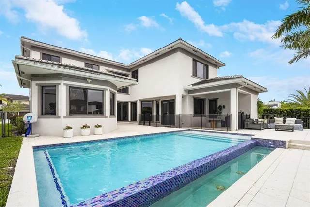 a view of a house with sitting area and swimming pool