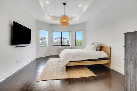 a bedroom with a bed and a flat screen tv
