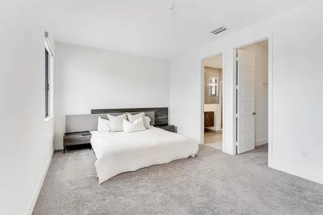 a bedroom with a bed and a night stand