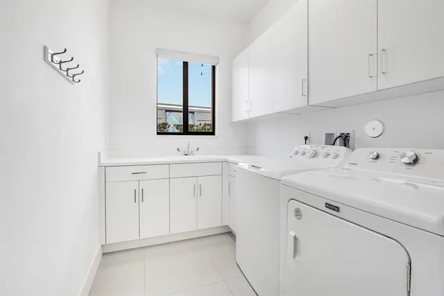a utility room with sink dryer and washer