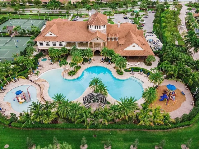 an aerial view of a house with outdoor space and swimming pool