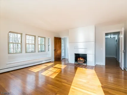 a living room with a fireplace and chandelier