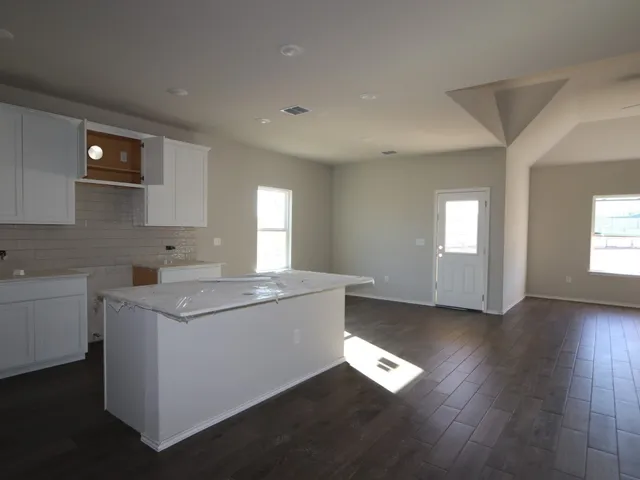a view of kitchen with stainless steel appliances granite countertop a sink and a stove top oven