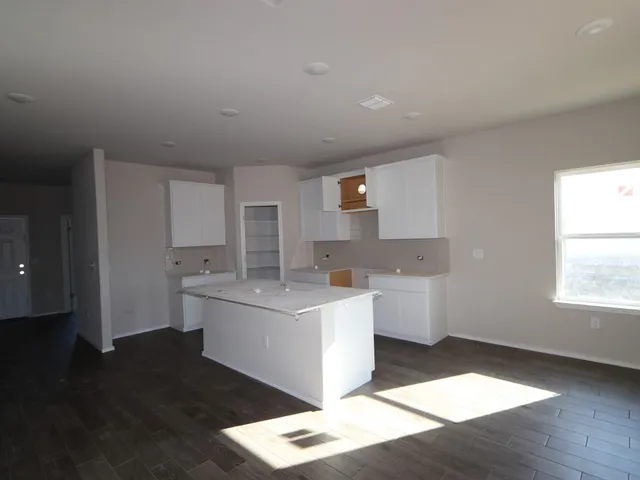 a kitchen with a sink stove and cabinets