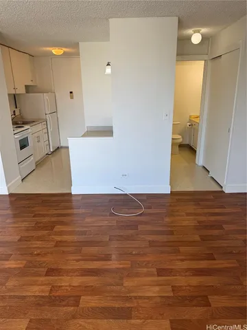 a bathroom with a granite countertop toilet and a shower