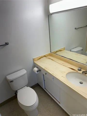 a white toilet sitting next to a bath tub