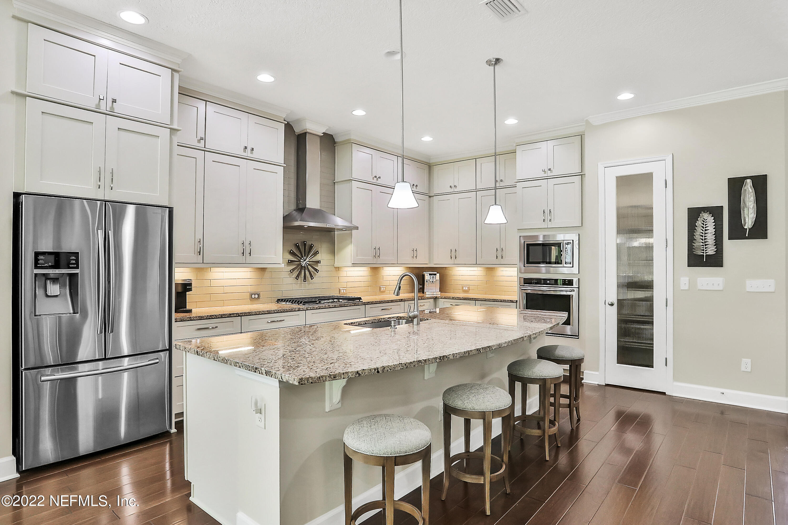 a kitchen with granite countertop a counter space stainless steel appliances and cabinets