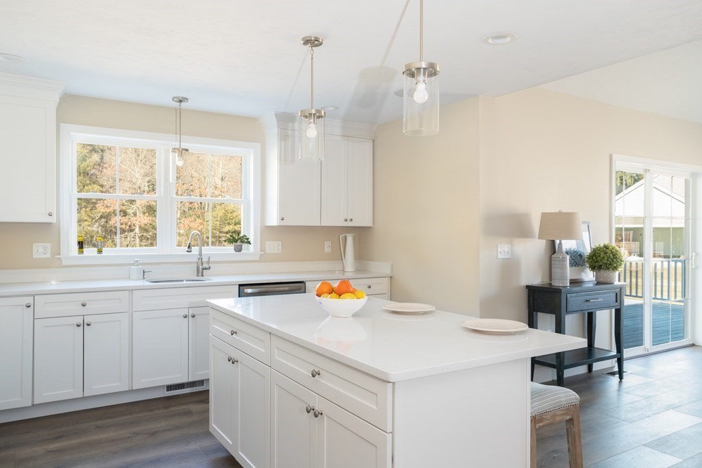 2 Katlyn Circle, Unit 15 Rochester, MA 02770 - Photo 11 of 16 a kitchen with a sink a center island cabinets and a window