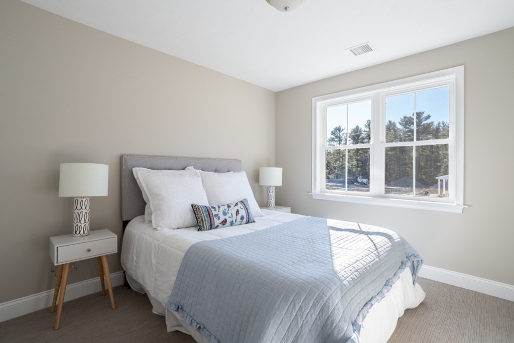2 Katlyn Circle, Unit 15 Rochester, MA 02770 - Photo 13 of 16 a bedroom with a bed and a window