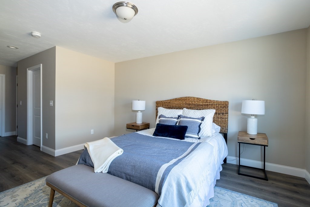 2 Katlyn Circle, Unit 15 Rochester, MA 02770 - Photo 7 of 16 a bedroom with a bed and a lamp