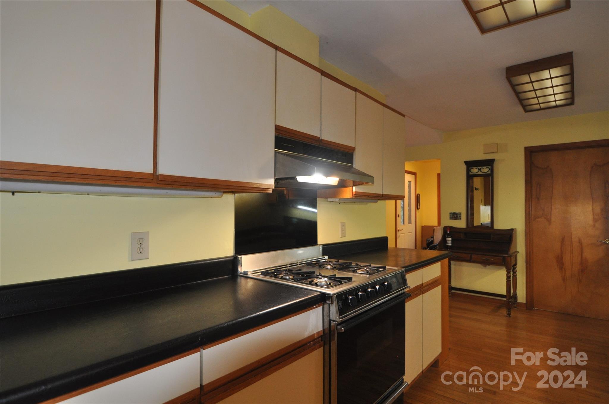 451 Bill Holbert Road Tryon, NC 28782 - Photo 29 of 35 a kitchen with stainless steel appliances granite countertop a stove and a refrigerator
