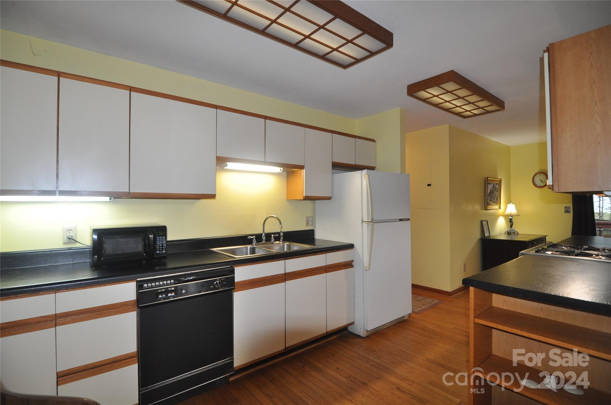 451 Bill Holbert Road Tryon, NC 28782 - Photo 30 of 35 a kitchen with granite countertop a sink a stove and refrigerator