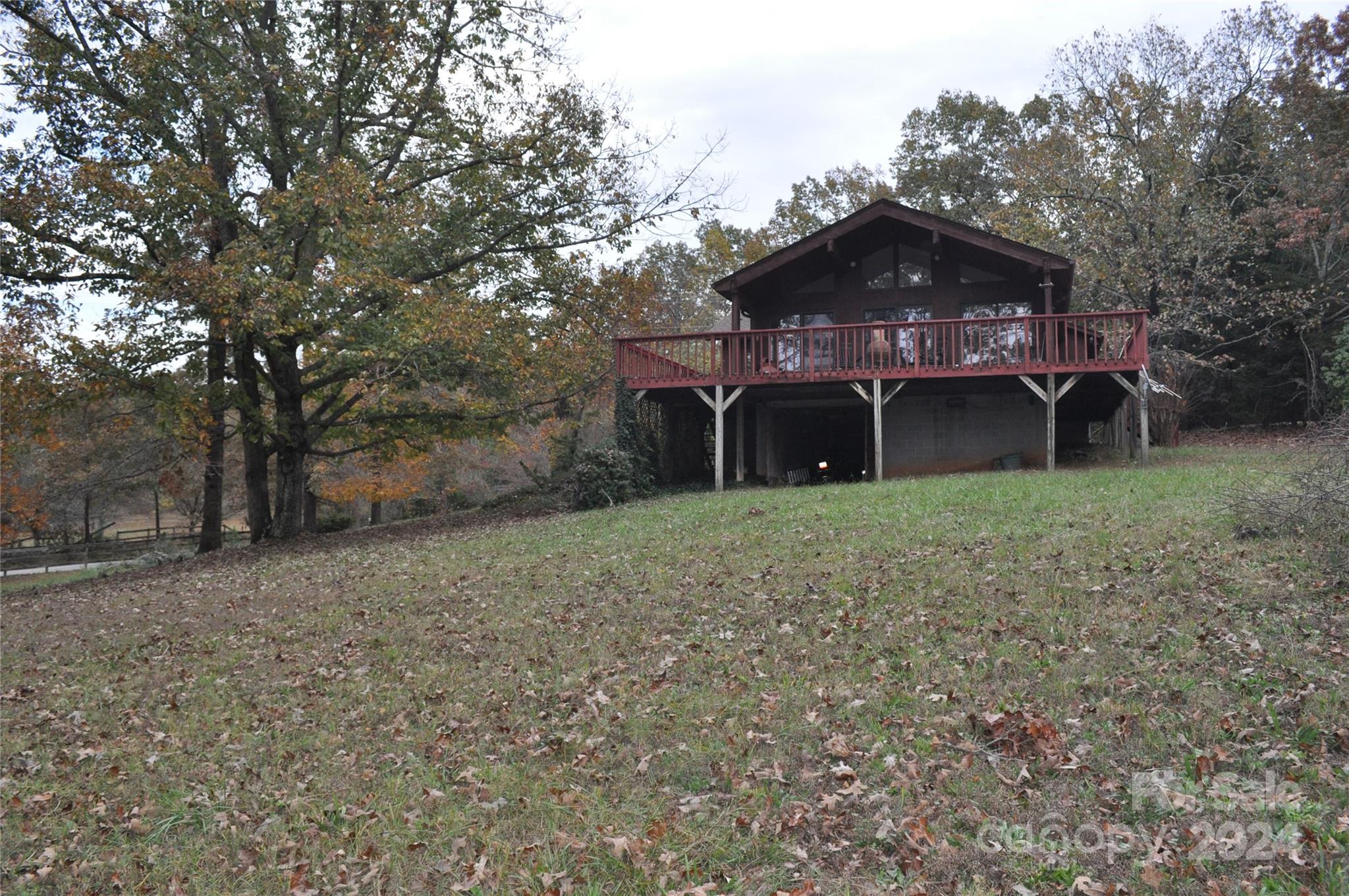 451 Bill Holbert Road Tryon, NC 28782 - Photo 9 of 35 a front view of a house with a yard and garage