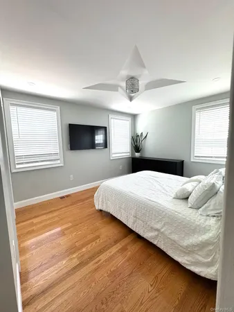 a bedroom with a large bed and a large window