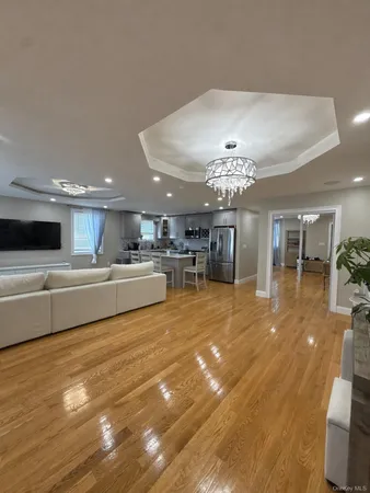 a living room with furniture and a chandelier
