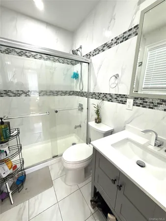a bathroom with a sink mirror and a shower