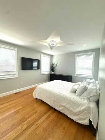 a bedroom with a large bed and a flat screen tv