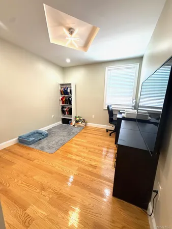 a room with a bed and a view of kitchen