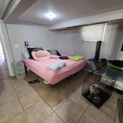 a bedroom with bed and a window