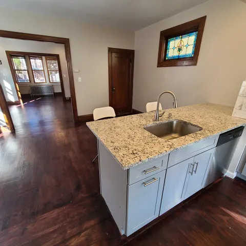 a kitchen with sink and mirror