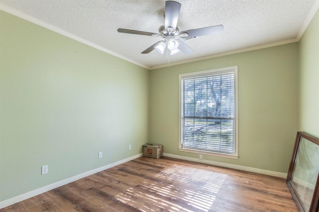 2622 Kendall Lane Waco, TX 76705 - Photo 24 of 40 Unfurnished room with ornamental molding, a textured ceiling, wood finished floors, and ceiling fan