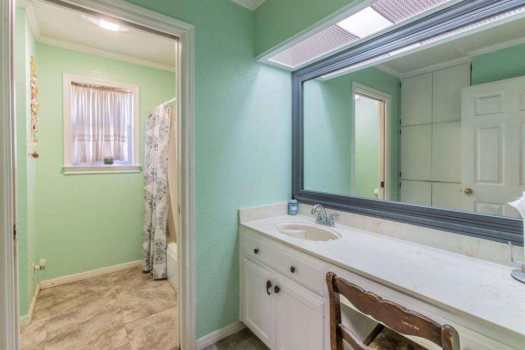 2622 Kendall Lane Waco, TX 76705 - Photo 30 of 40 Full bath with crown molding, vanity, shower / tub combo, and light tile patterned flooring