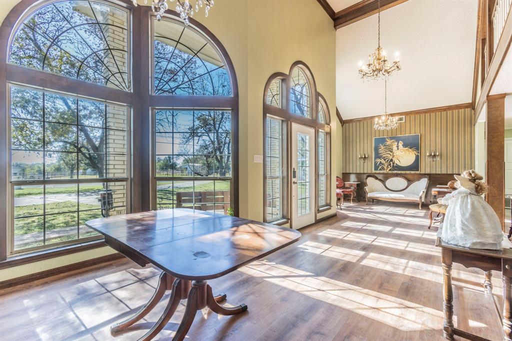 2622 Kendall Lane Waco, TX 76705 - Photo 8 of 40 Dining room featuring a chandelier, wood finished floors, ornamental molding, and a towering ceiling