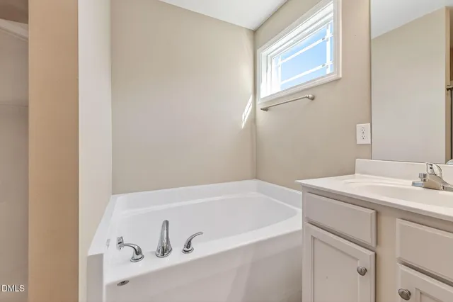 a bathroom with a sink and a window