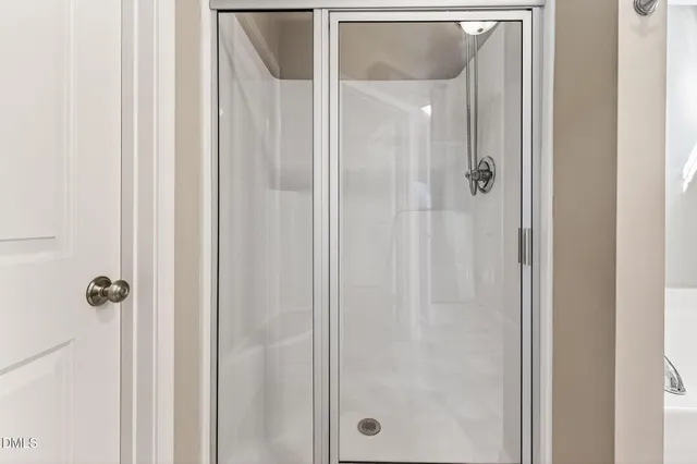 a bathroom with a glass shower door