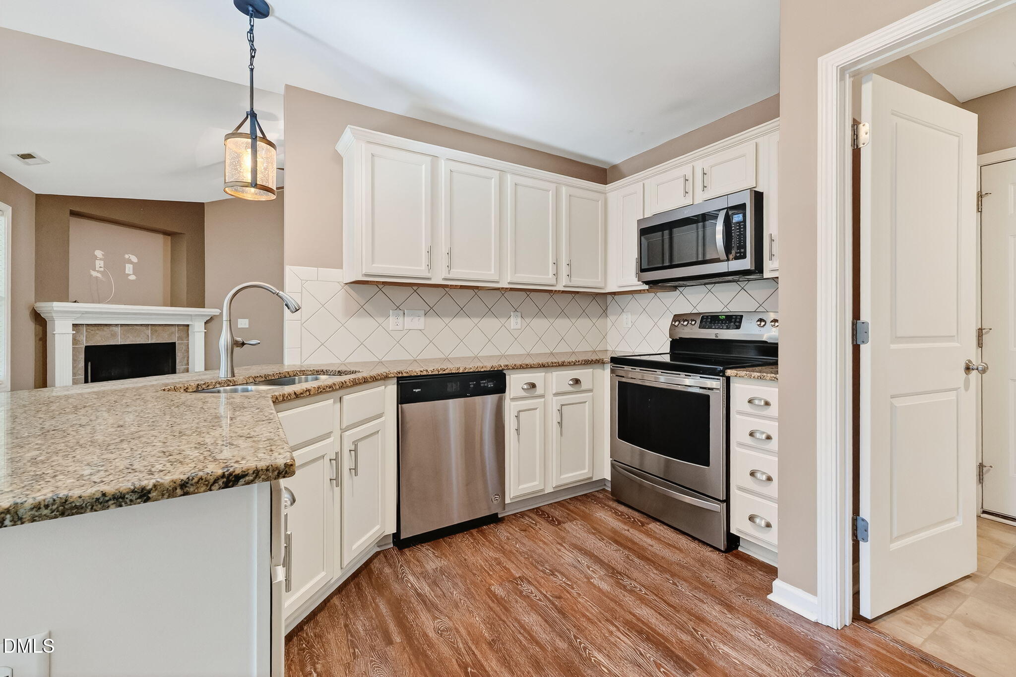 235 Highcroft Circle Benson, NC 27504 - Photo 4 of 17 a kitchen with granite countertop a sink cabinets stainless steel appliances and a window
