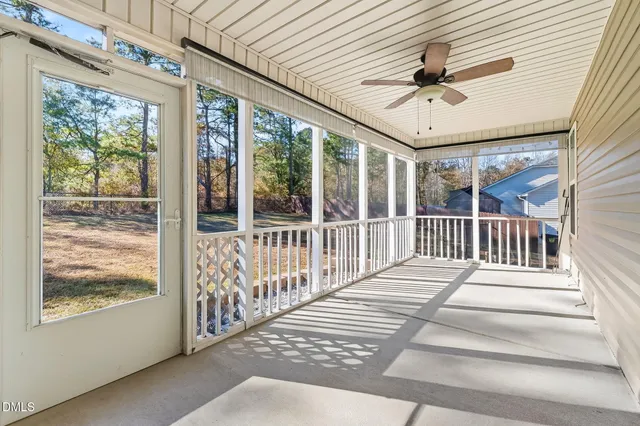 a view of a porch with wooden floor and a ceiling fan