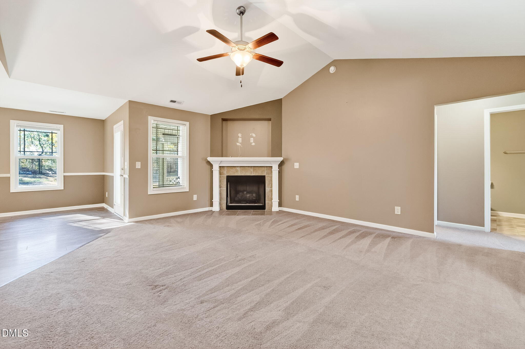 235 Highcroft Circle Benson, NC 27504 - Photo 7 of 17 an empty room with windows and fireplace