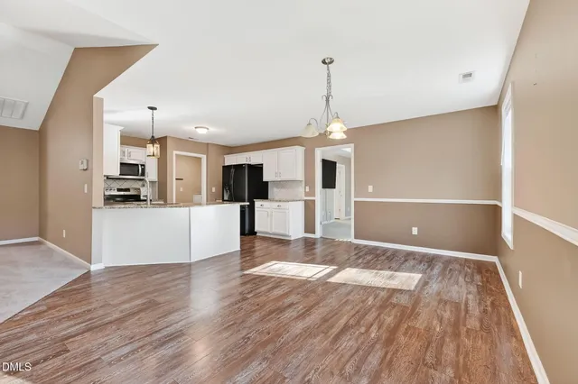 a view of kitchen with furniture and wooden floor