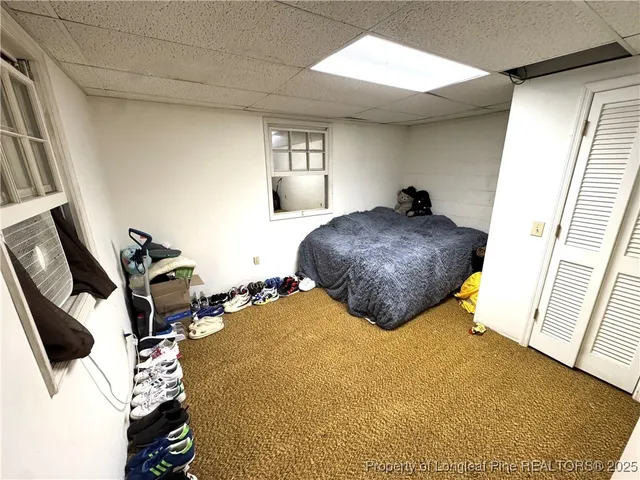 a bedroom with bed and window