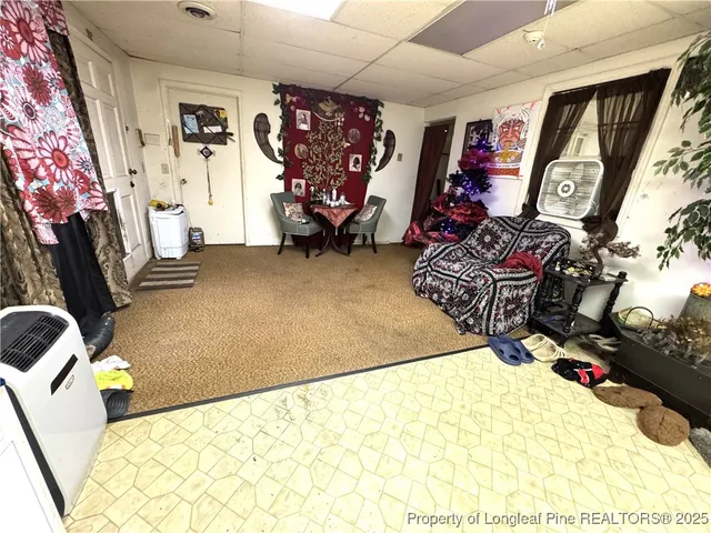 a workspace room with furniture and a window