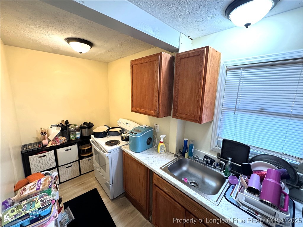 310 Old Hertford Ln Spring Lake Spring Lake, NC 28390 - Photo 18 of 30 a kitchen with a sink stove and cabinets