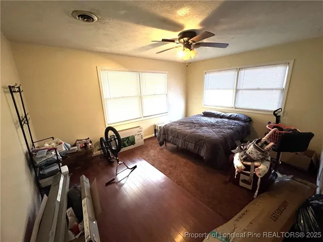a bedroom with furniture and a window
