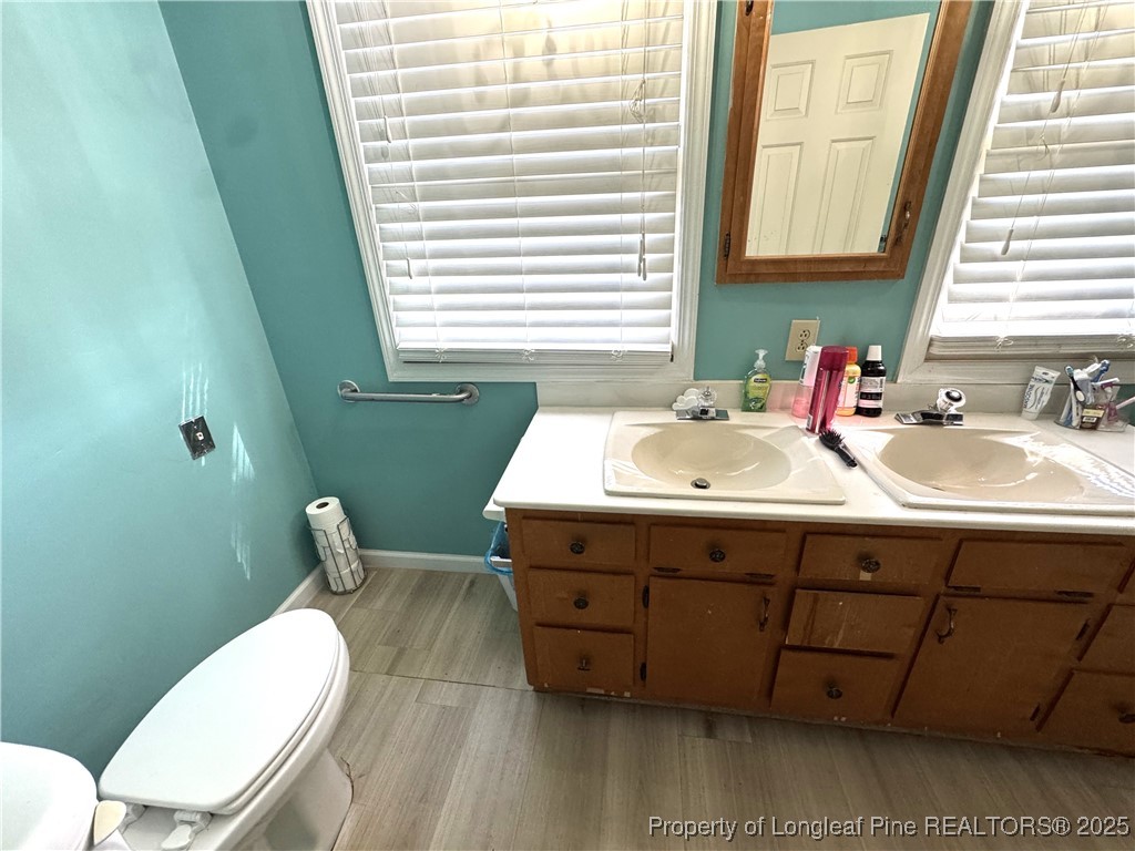 310 Old Hertford Ln Spring Lake Spring Lake, NC 28390 - Photo 23 of 30 a bathroom with a sink mirror toilet and window