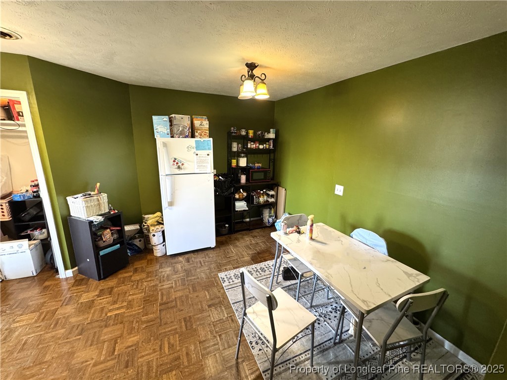 310 Old Hertford Ln Spring Lake Spring Lake, NC 28390 - Photo 27 of 30 a view of a dining room with furniture and chandelier