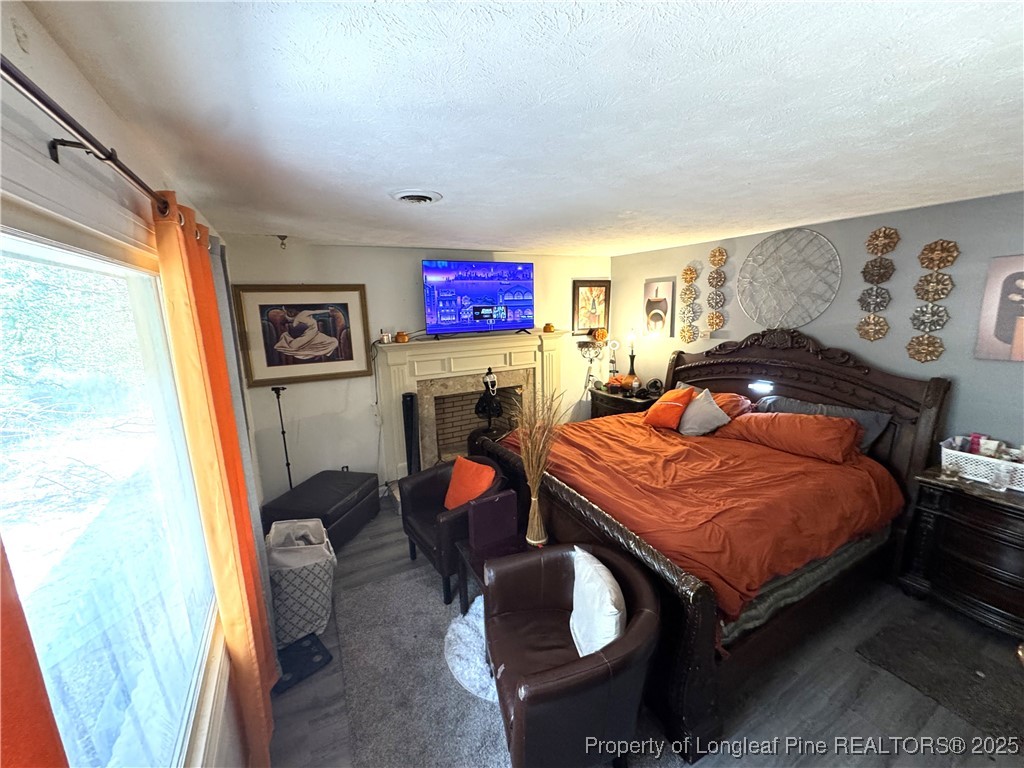 310 Old Hertford Ln Spring Lake Spring Lake, NC 28390 - Photo 8 of 30 a bedroom with a bed and wooden floor