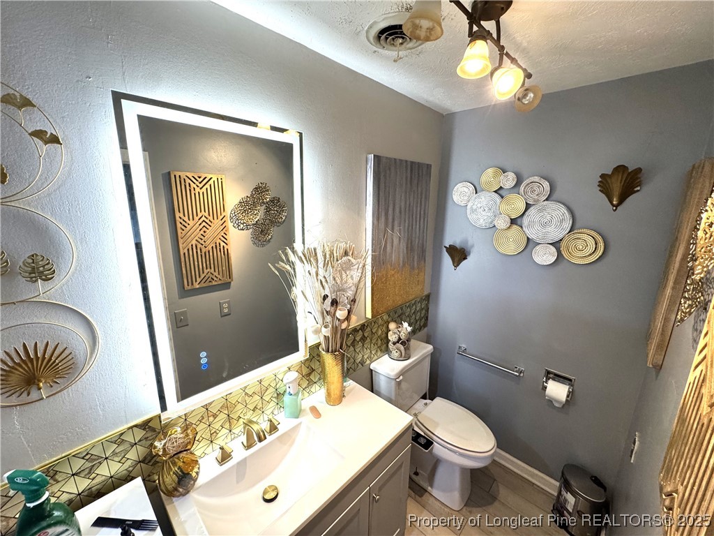310 Old Hertford Ln Spring Lake Spring Lake, NC 28390 - Photo 10 of 30 a bathroom with a sink a toilet and mirror