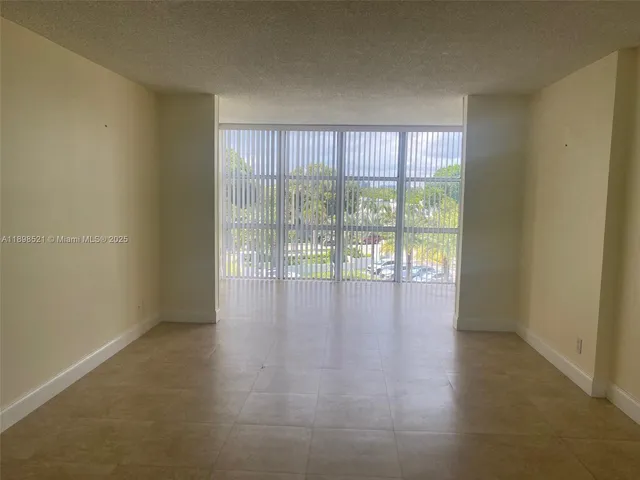 a view of a livingroom with wooden floor and sliding door
