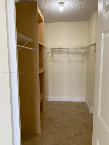 a kitchen with granite countertop a sink a stove and cabinets