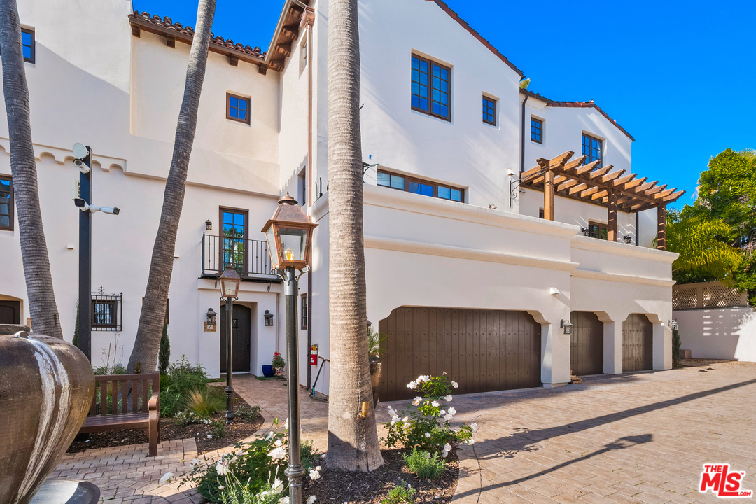 11937 Sunset Boulevard, Unit 7 Los Angeles, CA 90049 - Photo 1 of 1 a front view of a house with potted plants