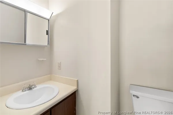 a bathroom with a sink a toilet and mirror