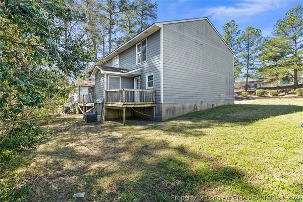 a view of a house with a yard and sitting area